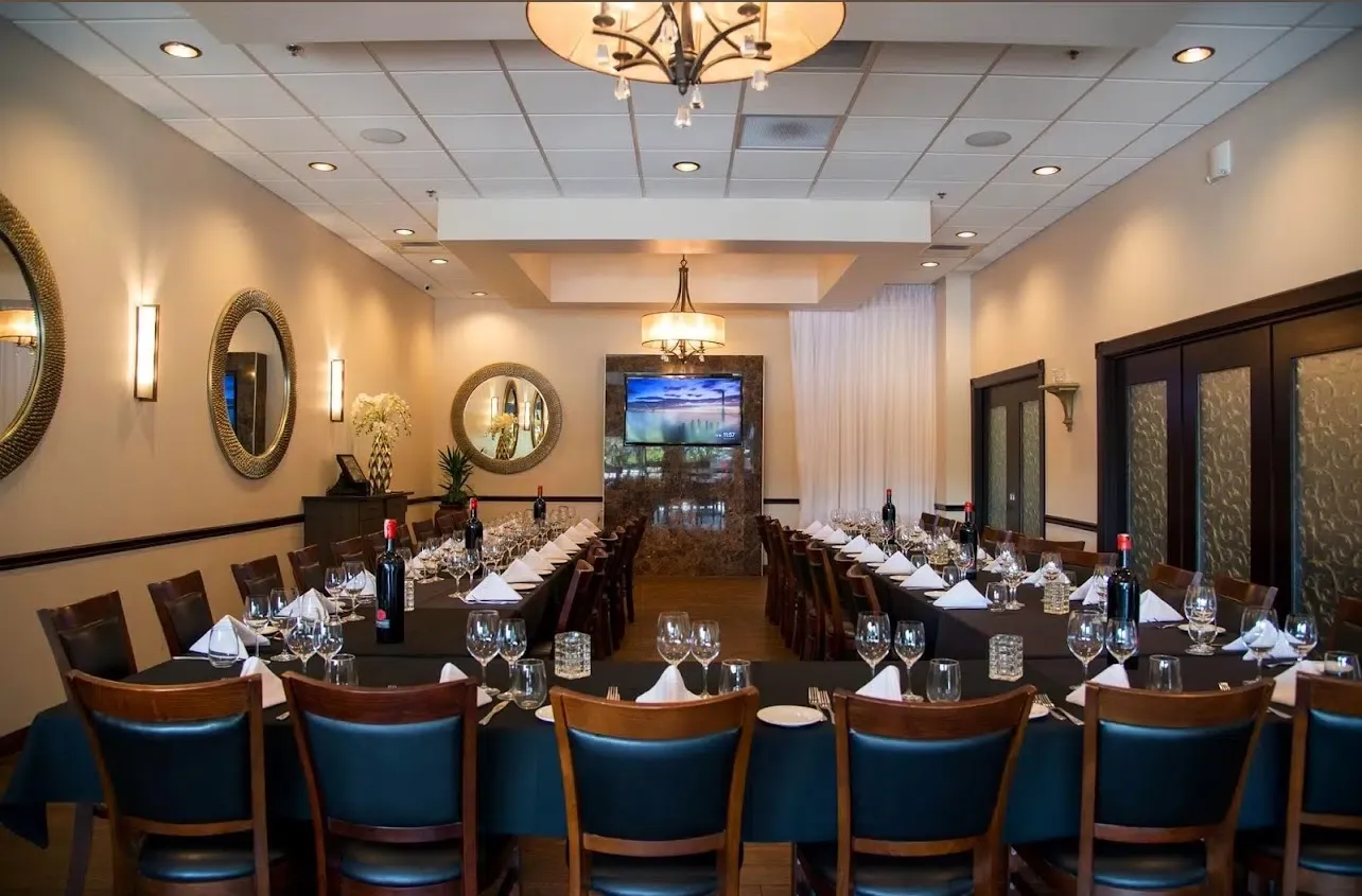 Private party setup with flowers in the Amalfi Room at Vincenzo Orlando